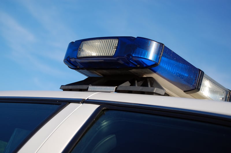 The Blue Lights Of A Police Car Set Upon A Blue Sky Background.jpg
