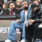 Drake Wearing Headphones To Do An In Game Interview While At A Raptors Game.jpg