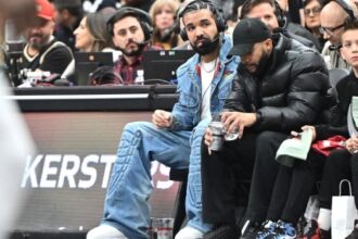 Drake Wearing Headphones To Do An In Game Interview While At A Raptors Game.jpg