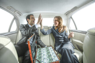 Two People Celebrating With Cash In A Car.jpg