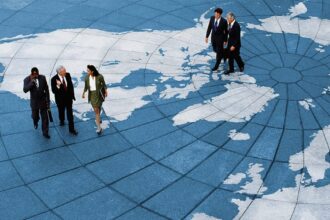 Business Professionals Walking Across A World Map Floor Gettyimages 91496535 1200w 628h.jpg