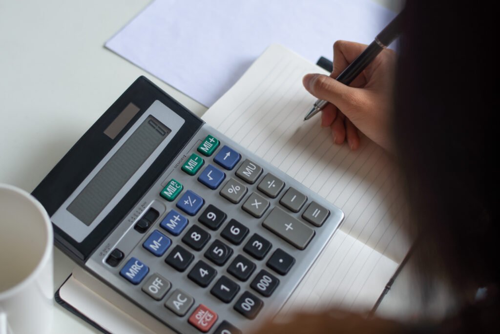 Close Up Of Woman Counting Figures While Preparing Tax