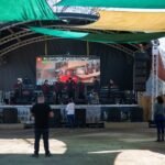 A handful of people listen to music from a band at the 812 Outdoor Market. Vendors say that on most weekends the floor would be full of dozens of couples dancing to the music, but fears of immigration