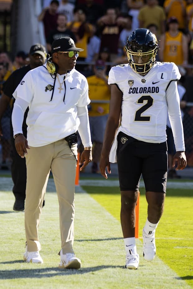 Oct 7, 2023; Tempe, Arizona, USA; Colorado Buffaloes head coach Deion Sanders with son and quarterback Shedeur Sanders (2) ag