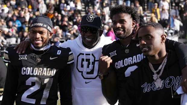Nov 29, 2024; Boulder, Colorado, USA; Colorado Buffaloes safety Shilo Sanders (21) and head coach Deion Sanders and quarterba
