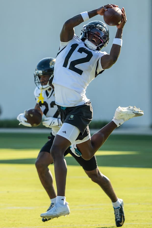 Jacksonville Jaguars wide receiver Travis Hunter (12) hauls in a pass while running a drill during an NFL training camp fourt