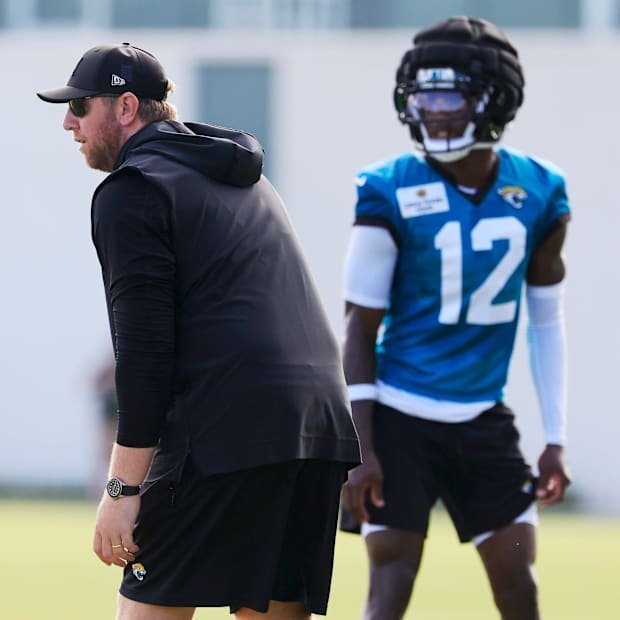 Jacksonville Jaguars head coach Liam Coen lines up against wide receiver Travis Hunter (12) during an NFL training camp sessi