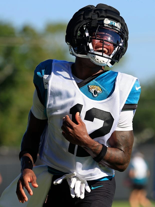 Jacksonville Jaguars wide receiver Travis Hunter (12) reacts during practices as cornerback Jarrian Jones (22) looks on durin