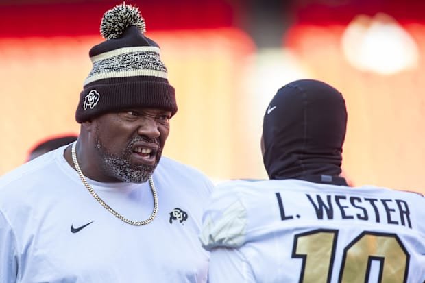Nov 23, 2024; Kansas City, Missouri, USA;  Colorado coach Warren Sapp motivates Colorado wide receiver LaJohntay Wester (10) 