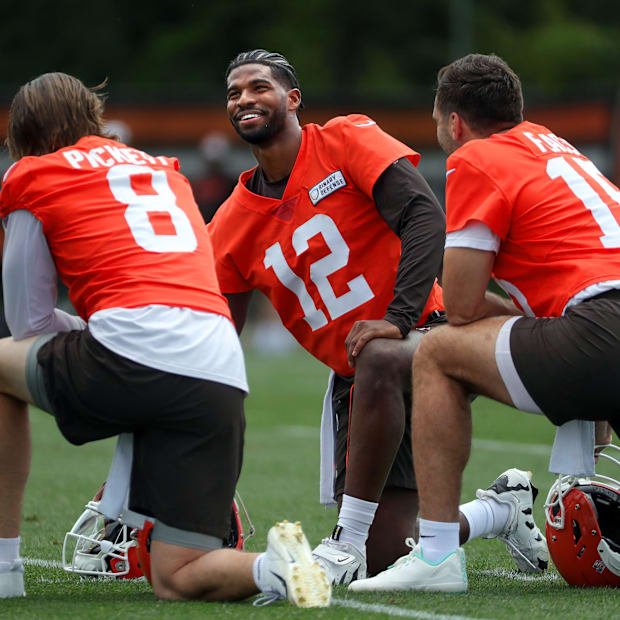 Browns quarterbacks Shedeur Sanders (12), Kenny Pickett (8) and Joe Flacco (15) talk during minicamp June 10, 2025, in Berea,